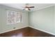 Bedroom with a large window, hardwood floors, ceiling fan and neutral paint at 3911 Ivy Ne Rd, Atlanta, GA 30342