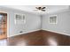 Bedroom features a ceiling fan, hardwood floors and plenty of natural light from the windows at 3911 Ivy Ne Rd, Atlanta, GA 30342