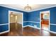 Dining room features hardwood floors and bright blue walls at 3911 Ivy Ne Rd, Atlanta, GA 30342