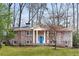 Charming brick home with a bright blue front door and a well-manicured lawn at 3911 Ivy Ne Rd, Atlanta, GA 30342