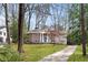 Elegant brick home with prominent columns, a well-manicured lawn, and inviting curb appeal at 3911 Ivy Ne Rd, Atlanta, GA 30342