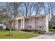Classic brick home with stately columns, beautiful landscaping, and a welcoming entrance at 3911 Ivy Ne Rd, Atlanta, GA 30342