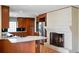 Bright kitchen featuring wood cabinets, stainless steel appliances, fireplace and tile flooring at 3911 Ivy Ne Rd, Atlanta, GA 30342