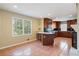Kitchen featuring a white brick fireplace, wood cabinets, stainless steel appliances and tiled floor at 3911 Ivy Ne Rd, Atlanta, GA 30342