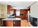 Kitchen featuring a fireplace, stainless steel appliances, wood cabinets, and island counter seating at 3911 Ivy Ne Rd, Atlanta, GA 30342