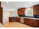 Well-lit kitchen featuring stainless steel appliances, black tile backsplash and wood cabinets at 3911 Ivy Ne Rd, Atlanta, GA 30342