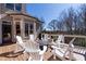 Inviting back deck with multiple chairs arranged around a fire pit, perfect for entertaining at 3955 Graystone Preserve Pl, Cumming, GA 30040