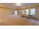 Finished basement with air hockey table and lots of natural light at 3955 Graystone Preserve Pl, Cumming, GA 30040