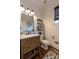Charming bathroom with wood vanity, stylish mirror, shiplap and a patterned rug at 3955 Graystone Preserve Pl, Cumming, GA 30040