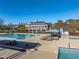 Community pool and lounge area with chairs, a hot tub, and beautiful landscaping, offering a resort-like experience at 3955 Graystone Preserve Pl, Cumming, GA 30040