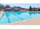 A large community swimming pool with lap lanes, sunshades, and lounge chairs at 3955 Graystone Preserve Pl, Cumming, GA 30040