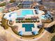 Aerial view of a community pool with lap lanes, a slide, sunshades, and lounge chairs at 3955 Graystone Preserve Pl, Cumming, GA 30040