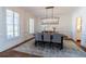 Dining room with dark wood table, seating for six, and modern light fixture at 3955 Graystone Preserve Pl, Cumming, GA 30040