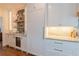 Custom bar with beverage refrigerator, sink, marble countertop and backsplash at 3955 Graystone Preserve Pl, Cumming, GA 30040