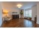 Comfortable living room with a decorative chair and dark stained hardwood floors at 3955 Graystone Preserve Pl, Cumming, GA 30040