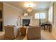 Inviting living room space with a fireplace, light fixture, window shutters, and neutral walls at 3955 Graystone Preserve Pl, Cumming, GA 30040