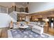 Inviting living room with large sectional sofa, hardwood floors, and view into the kitchen at 3955 Graystone Preserve Pl, Cumming, GA 30040