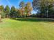 Beautiful backyard putting green, perfect for golf enthusiasts with lush, green grass at 3955 Graystone Preserve Pl, Cumming, GA 30040