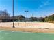Community tennis and sand volleyball courts with lighting for evening games at 3955 Graystone Preserve Pl, Cumming, GA 30040