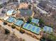 Aerial view of the neighborhood tennis courts and a pond in a well-planned, amenity-rich community at 3955 Graystone Preserve Pl, Cumming, GA 30040