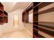 A walk-in closet with custom shelving and storage at 3955 Graystone Preserve Pl, Cumming, GA 30040