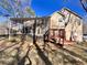 Rear exterior view featuring enclosed patio and wood deck with access to the yard at 884 Poole Bridge Rd, Hiram, GA 30141