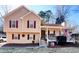 Charming two-story home with red shutters and a welcoming front porch, displaying the American flag at 884 Poole Bridge Rd, Hiram, GA 30141