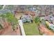 Aerial view of home with a long driveway, manicured lawn, and mature trees at 12867 Etris Walk, Roswell, GA 30075