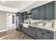 Finished basement with kitchenette featuring stainless steel appliances and stone counters at 12867 Etris Walk, Roswell, GA 30075