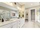 Bright bathroom featuring dual sinks, modern fixtures, marble countertops, and a glass-enclosed shower at 12867 Etris Walk, Roswell, GA 30075