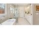 Modern bathroom with soaking tub, glass enclosed shower, and double vanity at 12867 Etris Walk, Roswell, GA 30075