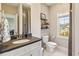 Well-lit bathroom featuring vanity with sink and a window at 12867 Etris Walk, Roswell, GA 30075
