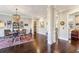 Open-concept dining room featuring dark wood floors, statement lighting, and stylish decor at 12867 Etris Walk, Roswell, GA 30075
