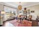 Sun-filled dining room featuring large windows, hardwood floors, statement chandelier, and modern decor at 12867 Etris Walk, Roswell, GA 30075