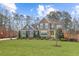 Charming two-story home with brick and siding exterior, blue shutters, and a bright yellow door at 12867 Etris Walk, Roswell, GA 30075