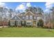 Beautiful two-story home with brick and siding exterior and well-manicured front lawn at 12867 Etris Walk, Roswell, GA 30075