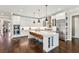 Spacious kitchen with white cabinets, stainless steel appliances, island with seating, and hardwood floors at 12867 Etris Walk, Roswell, GA 30075