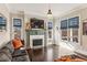 A cozy living room features a fireplace, large windows with custom blinds and hardwood flooring at 12867 Etris Walk, Roswell, GA 30075