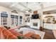 Bright living room with coffered ceilings, large windows, fireplace with built-ins, and hardwood floors at 12867 Etris Walk, Roswell, GA 30075