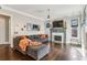 Living room with fireplace, large windows, hardwood flooring, and a comfortable sectional sofa at 12867 Etris Walk, Roswell, GA 30075