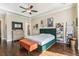 A large main bedroom features a decorative ceiling, ample space, hardwood floors, and lots of natural light at 12867 Etris Walk, Roswell, GA 30075