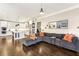 Spacious open floorplan with a kitchen featuring a large island flowing into a living area with a sectional sofa at 12867 Etris Walk, Roswell, GA 30075