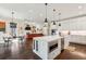 Open floorplan with kitchen island, dining area, and living room with fireplace, providing a great entertaining space at 12867 Etris Walk, Roswell, GA 30075