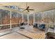 Relaxing screened-in porch with comfortable seating and ceiling fan overlooking private backyard at 12867 Etris Walk, Roswell, GA 30075