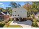 View of the home's back exterior featuring a deck, stone accents and an extended driveway at 1819 Avon Ave, Atlanta, GA 30311