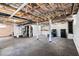 Unfinished basement space with exposed ceiling, offering ample storage or renovation potential with washer and dryer at 1819 Avon Ave, Atlanta, GA 30311