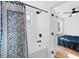 Bright bathroom featuring a shower-over-tub combo and a decorative blue curtain, offering a modern and stylish space at 1819 Avon Ave, Atlanta, GA 30311