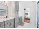 A well-lit bathroom features a vanity with grey cabinets and modern fixtures at 1819 Avon Ave, Atlanta, GA 30311