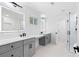 A modern bathroom features dual vanities, sleek fixtures, and a glass-enclosed shower at 1819 Avon Ave, Atlanta, GA 30311