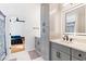 A modern bathroom features a vanity with grey cabinets and modern fixtures at 1819 Avon Ave, Atlanta, GA 30311